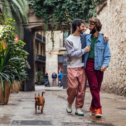 gay male couple walking with their dog