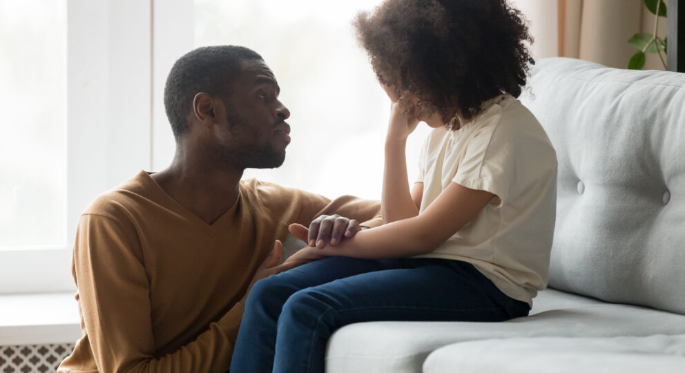 Parent comforting emotionally upset child