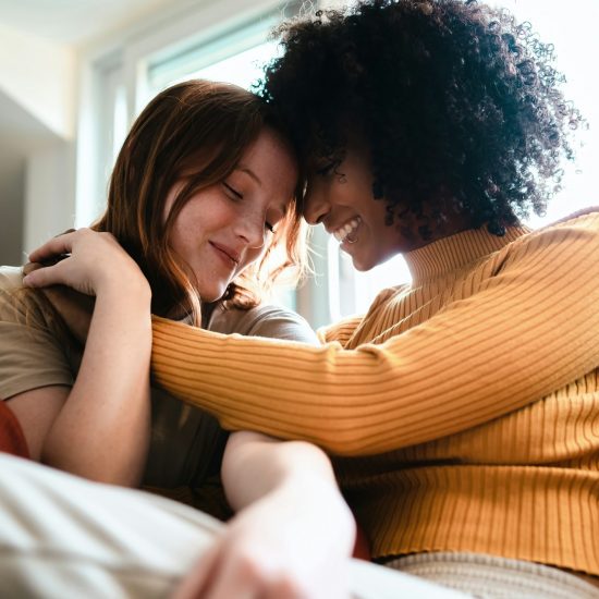 Lesbian women caressing on the couch